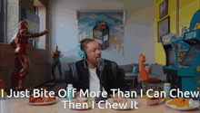 a man wearing headphones says " i just bite off more than i can chew then i chew it " in a room