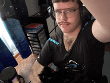 a man with glasses and a mustache is holding a cat