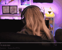 a woman wearing headphones is sitting in front of a screen that says queen hancho97tx