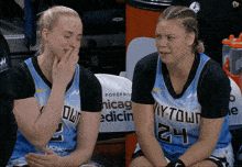 two female basketball players wearing jerseys with the number 24
