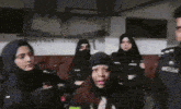 a group of women are standing in a room with a man wearing a badge that says ' police '