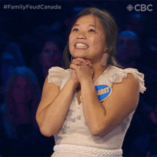 a woman in a white dress has a name tag that says caret