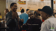 a group of men are standing in front of a menu that says buffalo wings