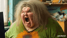 a woman with a sunflower shirt on is screaming