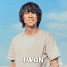 a man wearing a white t-shirt with the word i won on it
