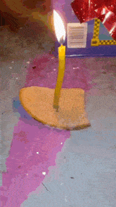 a candle is lit up on a piece of bread