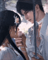 a man and woman are holding hands under an umbrella