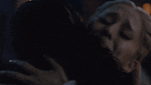 a woman is crying in a dark room