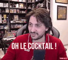 a man in a red shirt with the words oh le cocktail on it