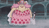 a woman in a pink dress with polka dots is standing next to a man with a sword