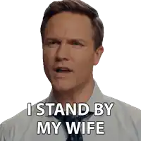 a man in a white shirt and tie says i stand by my wife