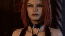 a woman with red hair is wearing a choker and a black top .