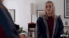 a woman in a living room with a netflix logo
