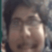 a blurry picture of a person 's face with glasses