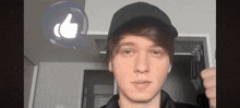 a young man wearing a hat and ear buds is giving a thumbs up sign .