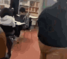 a blurry picture of a group of people sitting in a classroom