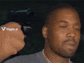a person is pointing a gun at a man 's face with a viggle.ai logo on the bottom right