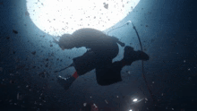 a man is singing into a microphone while swimming in the water