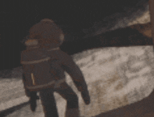 a blurred image of a person standing in front of a body of water