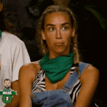 a woman wearing overalls and a green bandana is sitting in front of a sign that says milos 2 .