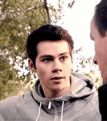 a young man wearing a grey nike hoodie