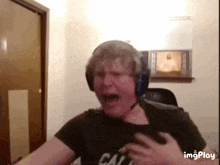 a man wearing headphones and a shirt that says cal