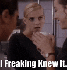 a woman is talking to a man with the words i freaking knew it