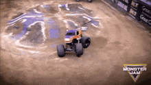 a monster jam truck is driving on a dirt road