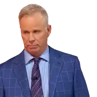 a man in a blue suit and tie is looking at something