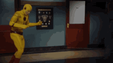 a man in a yellow superhero costume is dancing in a hallway with a sign that says the flash on it