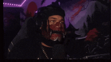a man wearing a mask and headphones is looking at the camera