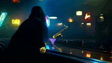 a person sitting at a bar with a martini in front of a sign that says ' caffe '