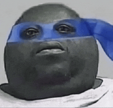 a close up of a person 's face with a blue mask on .