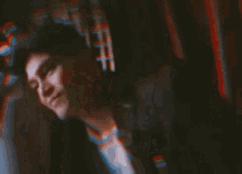 a blurry picture of a person 's face with a blurred background