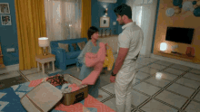 a man and a woman are standing in a living room