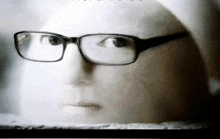 a close up of a person wearing glasses