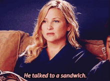 a woman is sitting on a couch and talking to a sandwich