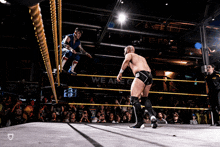 two wrestlers in a ring with a sign that says we are c