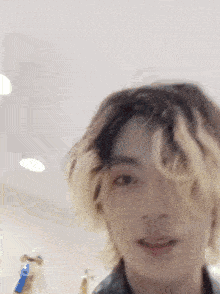 a close up of a person 's face with a blurred background .