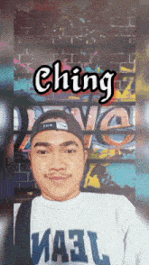 a man wearing a hat and a shirt that says ' ching '