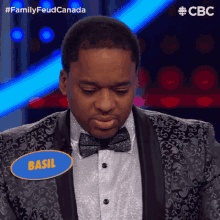 a man in a tuxedo with a name tag that says basil on it