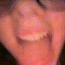 a blurry picture of a person 's mouth with a ring on their finger .