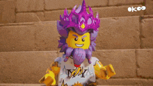 a lego character with purple hair and a white shirt with the letter y on the back