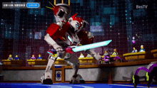 a robot is holding a sword in front of a bestv sign