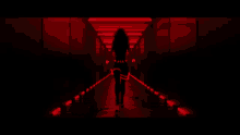 a blurred image of a dark hallway with red lights on the walls