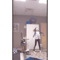 a girl is dancing in front of a mirror wearing a t-shirt that says " i love you "