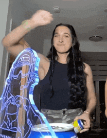 a woman with long hair is holding a can of pepsi