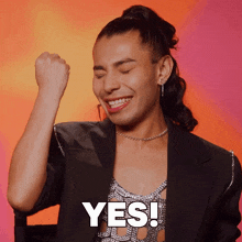 a man with his fist in the air and the word yes on his face