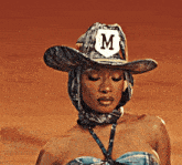 a woman wearing a cowboy hat and a scarf around her neck .