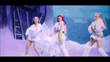 a group of women are dancing in the snow while wearing white clothes .